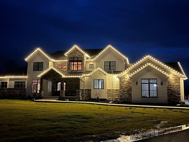 Warm white holiday roofline lighting at dusk, full front elevation